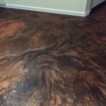 A floor that has been painted with brown and tan colors.