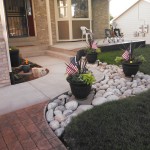 A patio with two american flags in the middle of it.