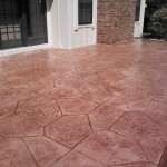 A patio with a large pattern of concrete.