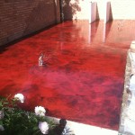 A red floor with flowers in the background