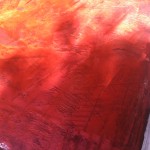 A red painting with some writing on it