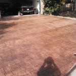 A car parked in the driveway of a house.