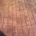 A brick floor with some brown bricks on it