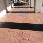 A walkway with black and white tiles on the ground.