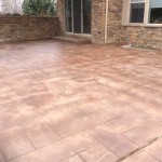 A patio with brick and stone flooring in the middle of it.