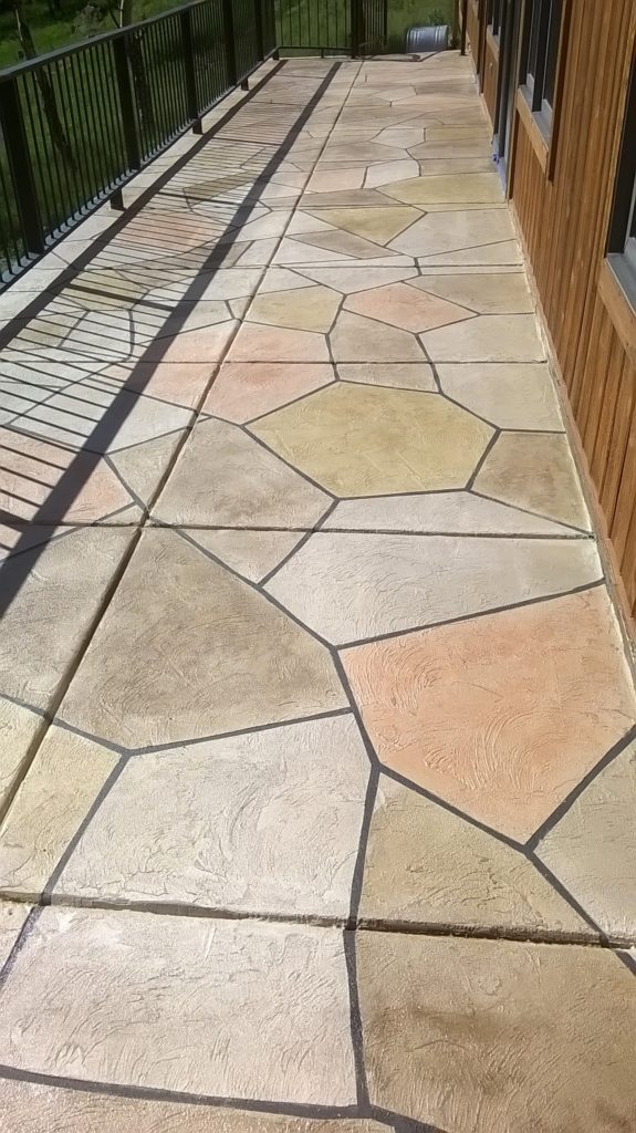 A walkway with different colored stones on it.