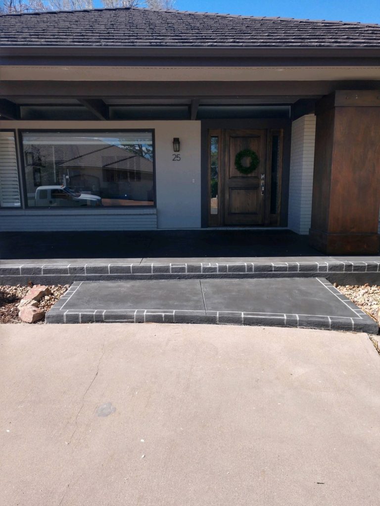 A front entrance of a house with a door open.